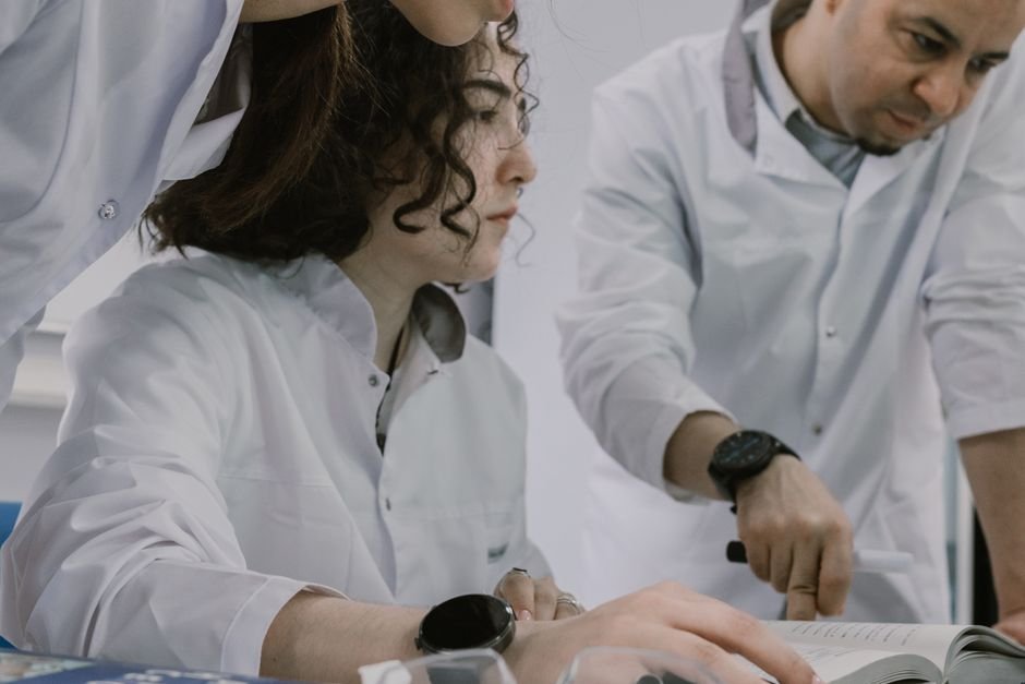 Group of scientists working together in a lab, focused and collaborative atmosphere.